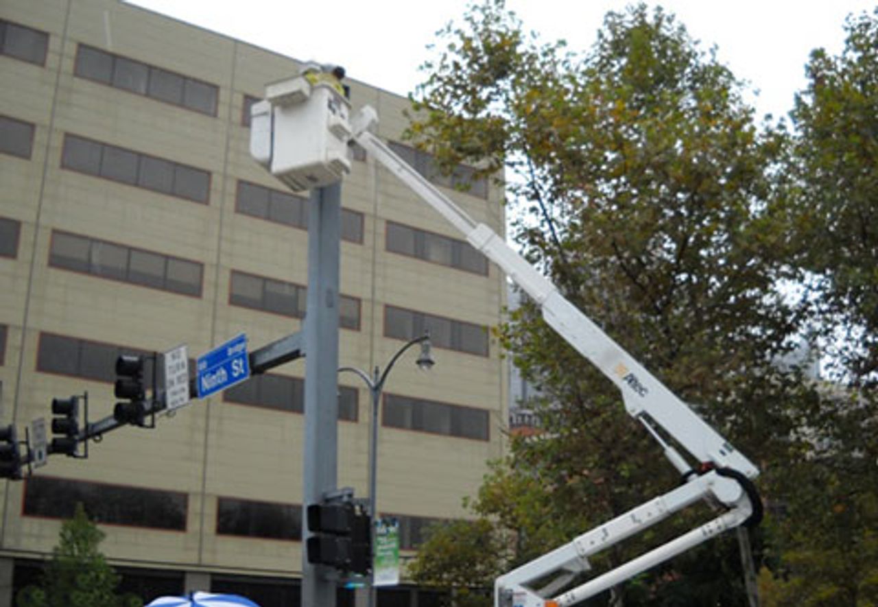 Workers installing video cameras to record protestors