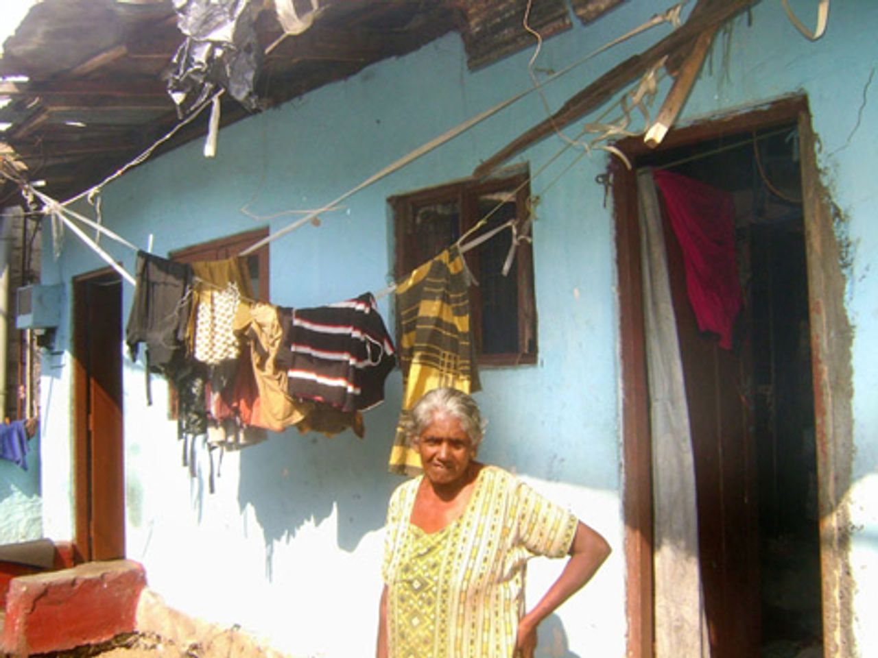 Nishantha's mother outside her home
