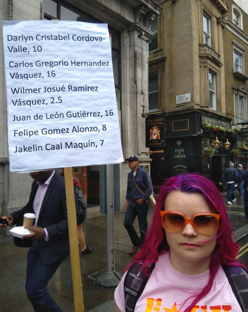 London anti-Trump demonstrator Rachel, with sign with the names of the children who have died whilst being detained by the Trump administration in the USA