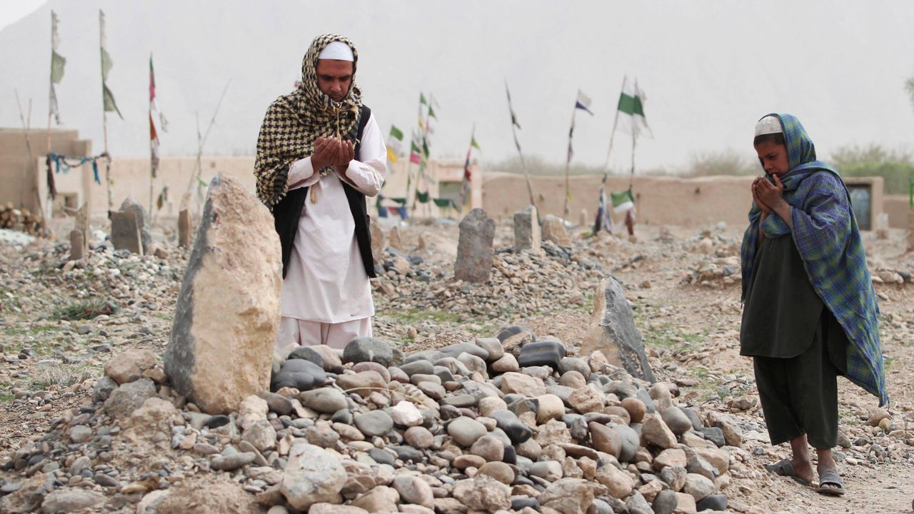 Afghan villagers pray over the grave of one of the 16 victims killed in a shooting rampage by a US soldier in the Panjwai district of Kandahar province south of Kabul, Afghanistan, Saturday, March 24, 2012. (AP Photo/Allauddin Khan)