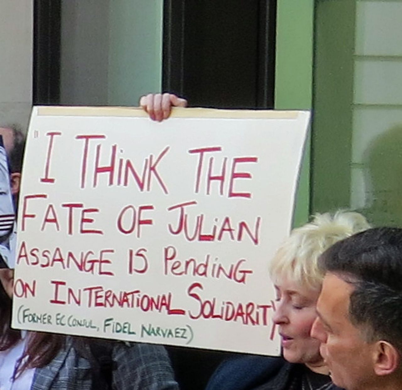 Christine holding international solidarity banner