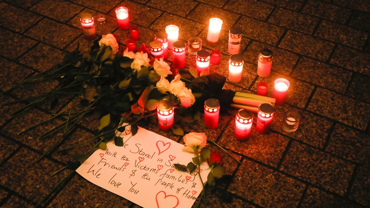 Candles and flowers placed on the floor during a vigil for victims of last night’s shooting in the central German town Hanau, at the Brandenburg Gate in Berlin, Germany, February 20, 2020. Credit: AP Photo/Markus Schreiber