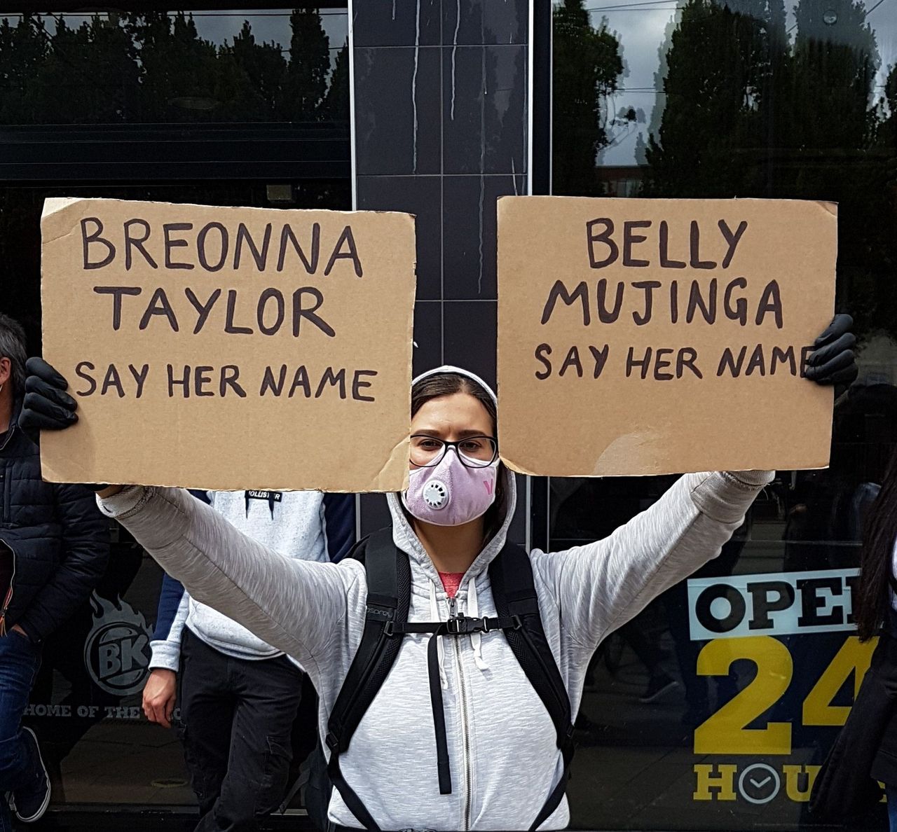 A protester in Manchester, England with placards referring to the police killing of US African-American woman Breonna Taylor and the preventable death of coronavirus of UK rail worker Belly Mujinga