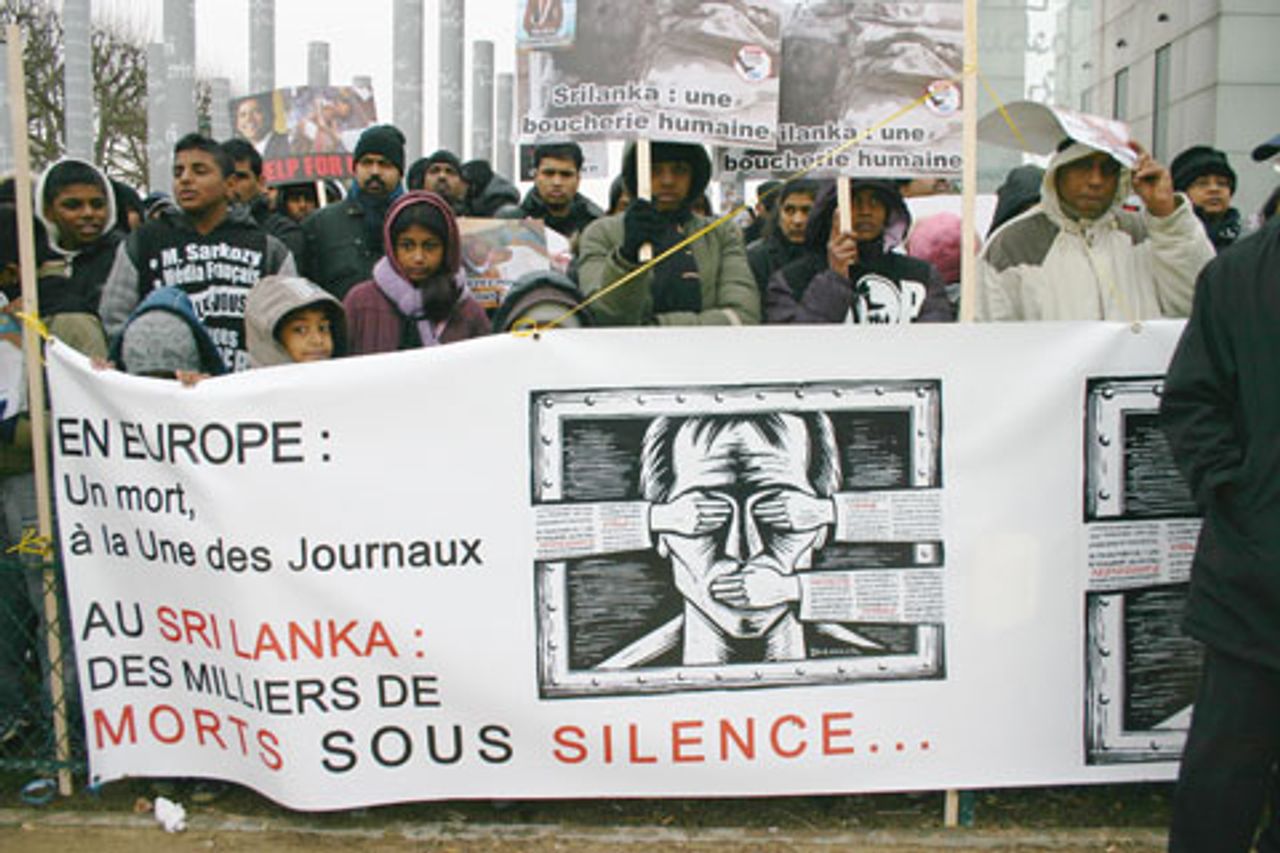 Demonstrators in Paris, banner reads: In Europe, not a word on the front pages of the newspaper--In Sri Lanka, thousands of dead unreported