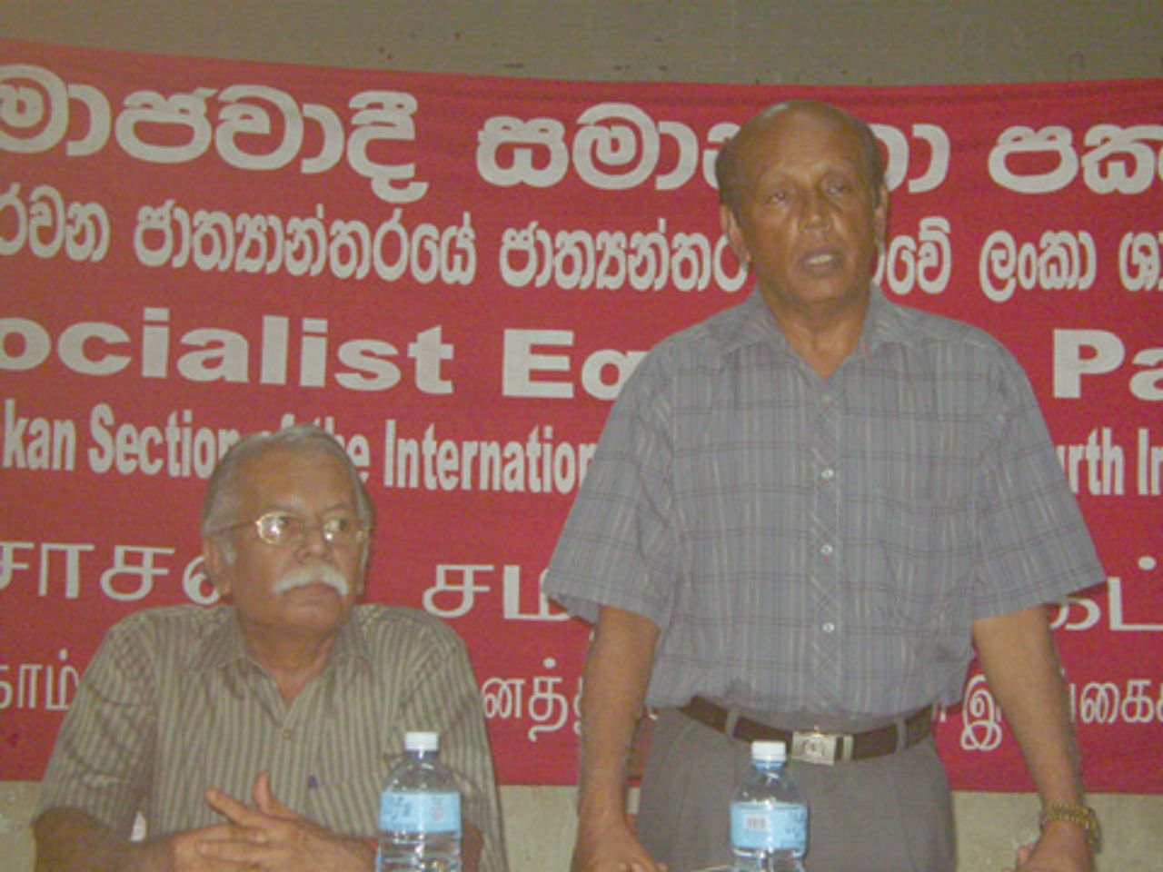 Ratnasiri Malalagama (speaking) alongside Wije Dias