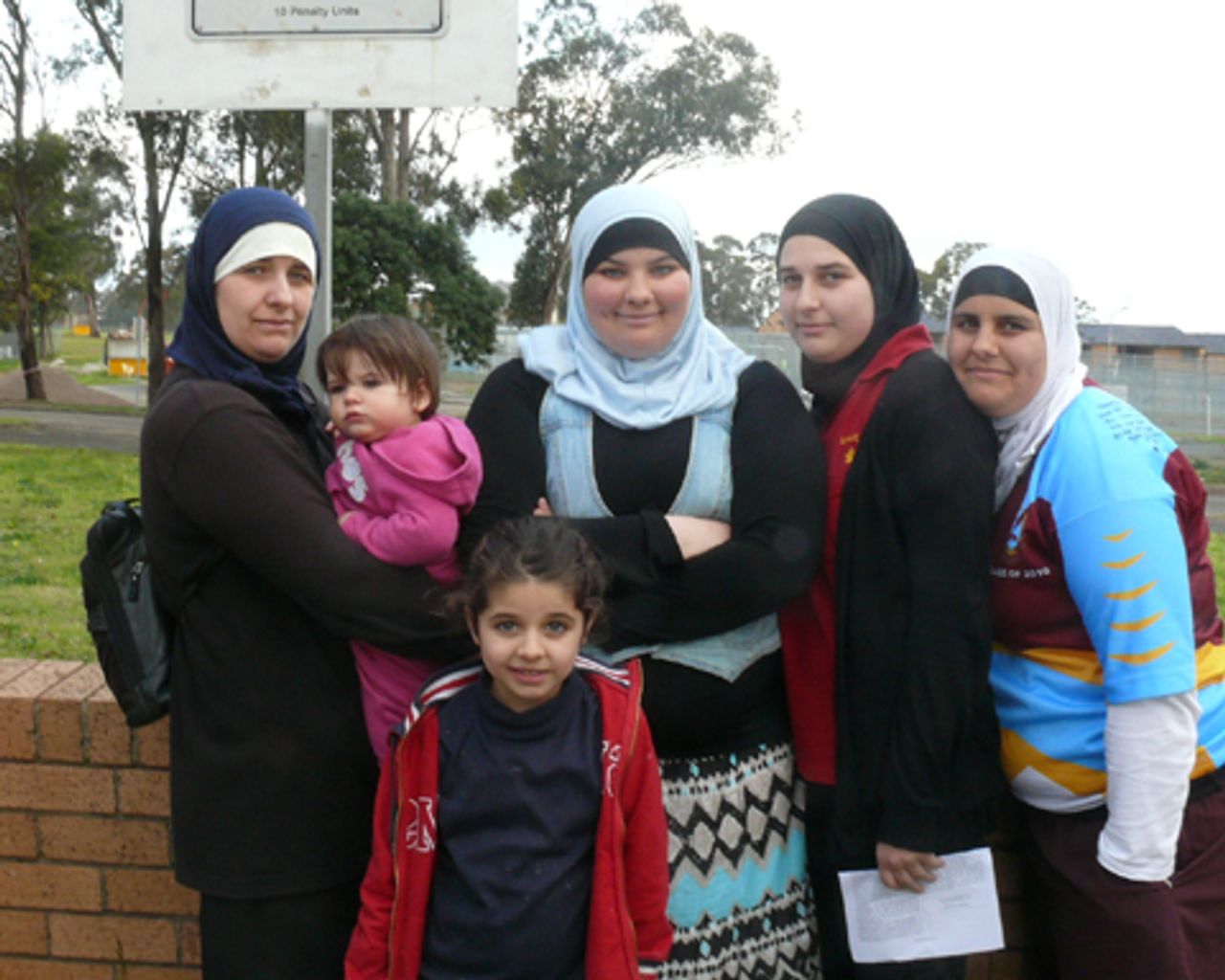 Halime Abdul-Rahman (left) with neice Mariam (centre in blue) and other family members