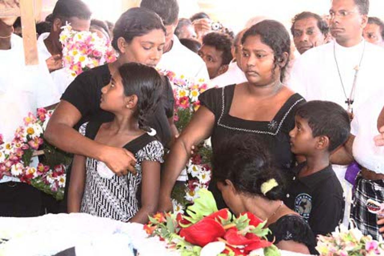 Warnakulasuriya's grieving wife (right) and two children