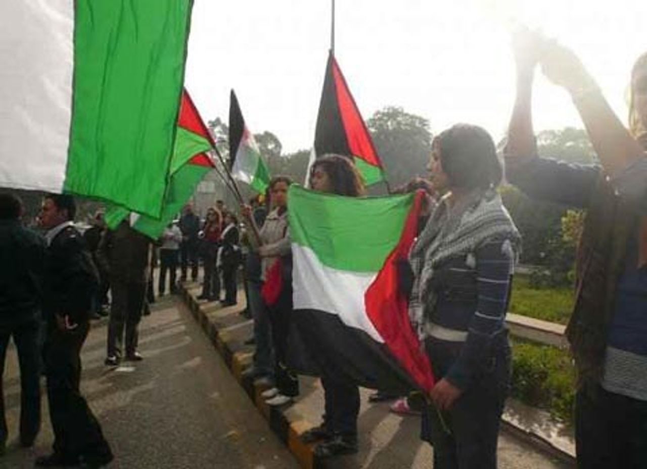 Women protesting with Palestinian flags in front of the Israeli embassy in Cairo