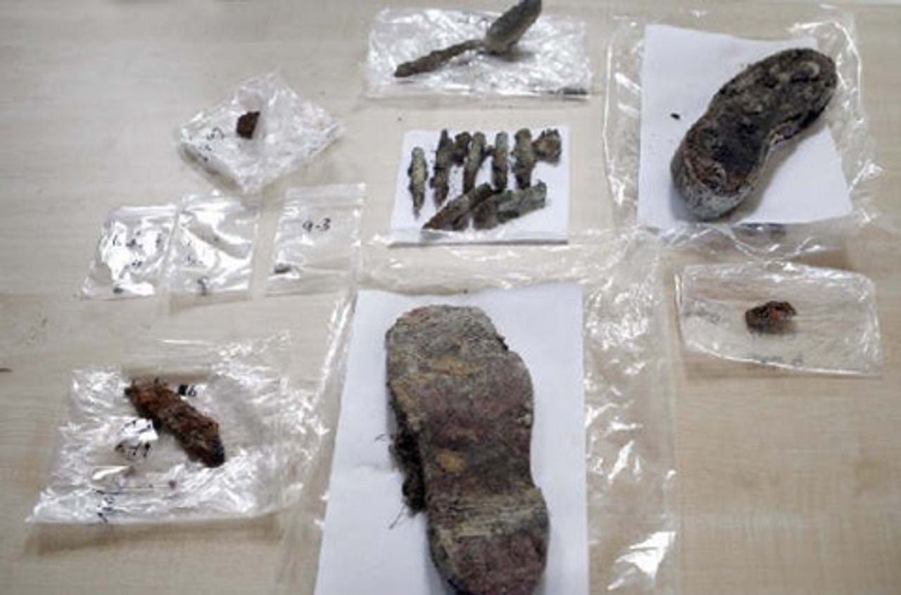 Among the objects exhumed from the grave were human remains, clothing, cutlery and ammunition.